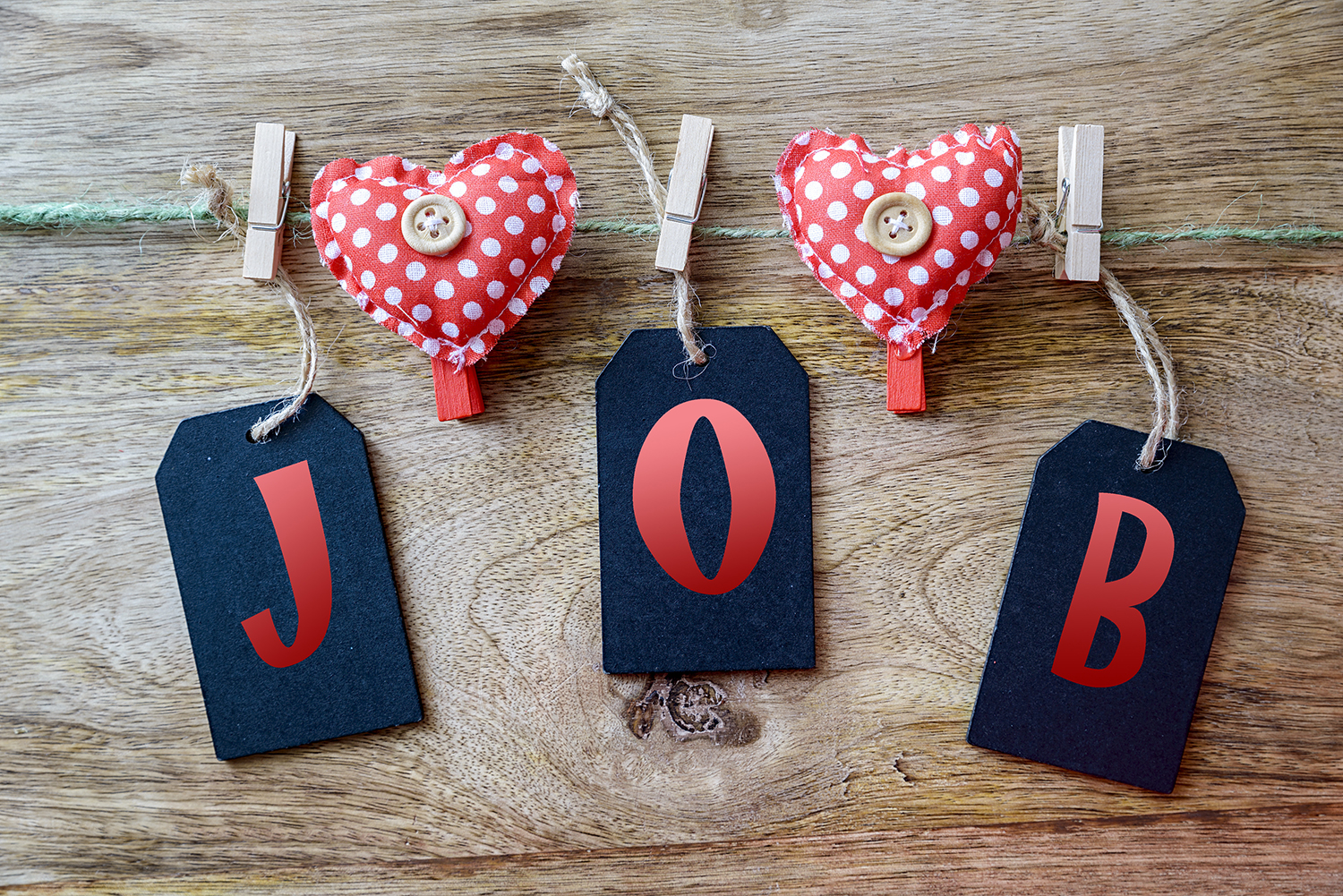 String with hearts attached and the word "Job" hanging by clips