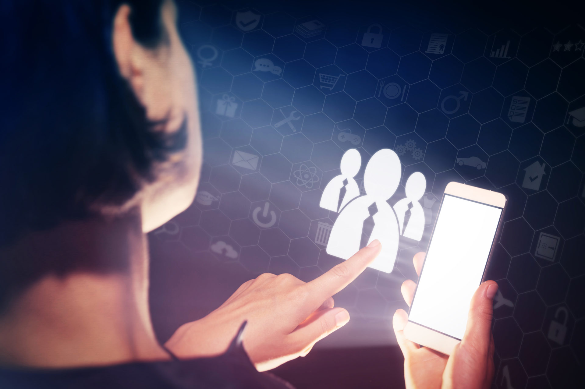 Female professional holding an iPhone and tapping on a professional on the screen