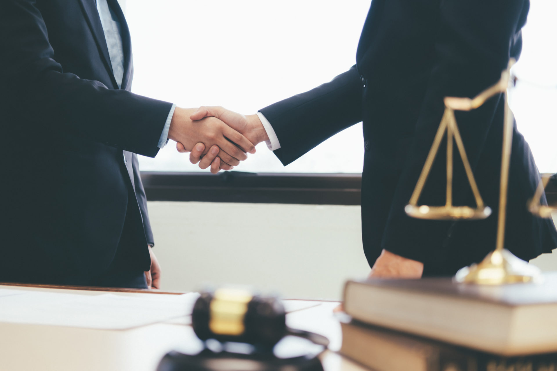 Two legal professionals shaking hands