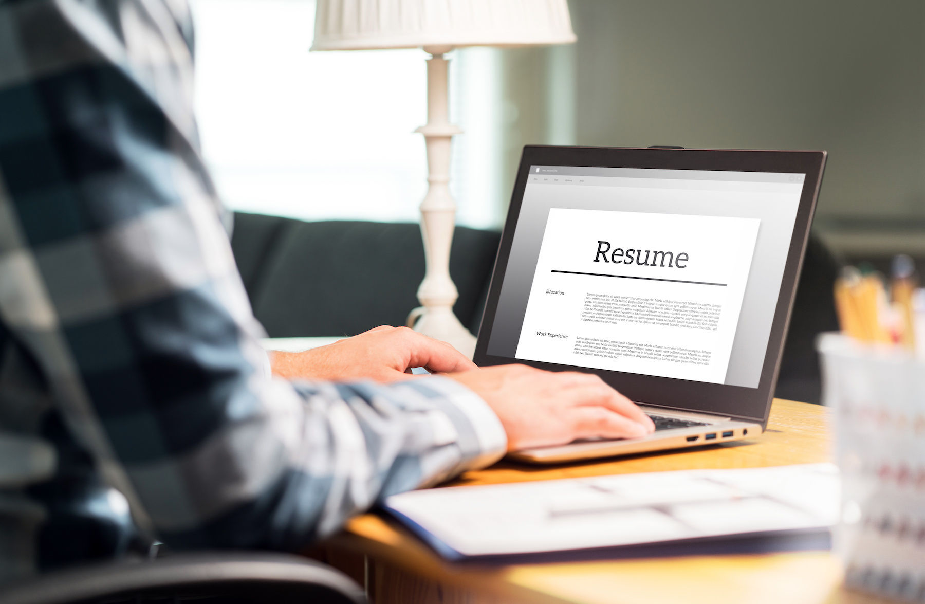 Male looking at a resume on his computer screen