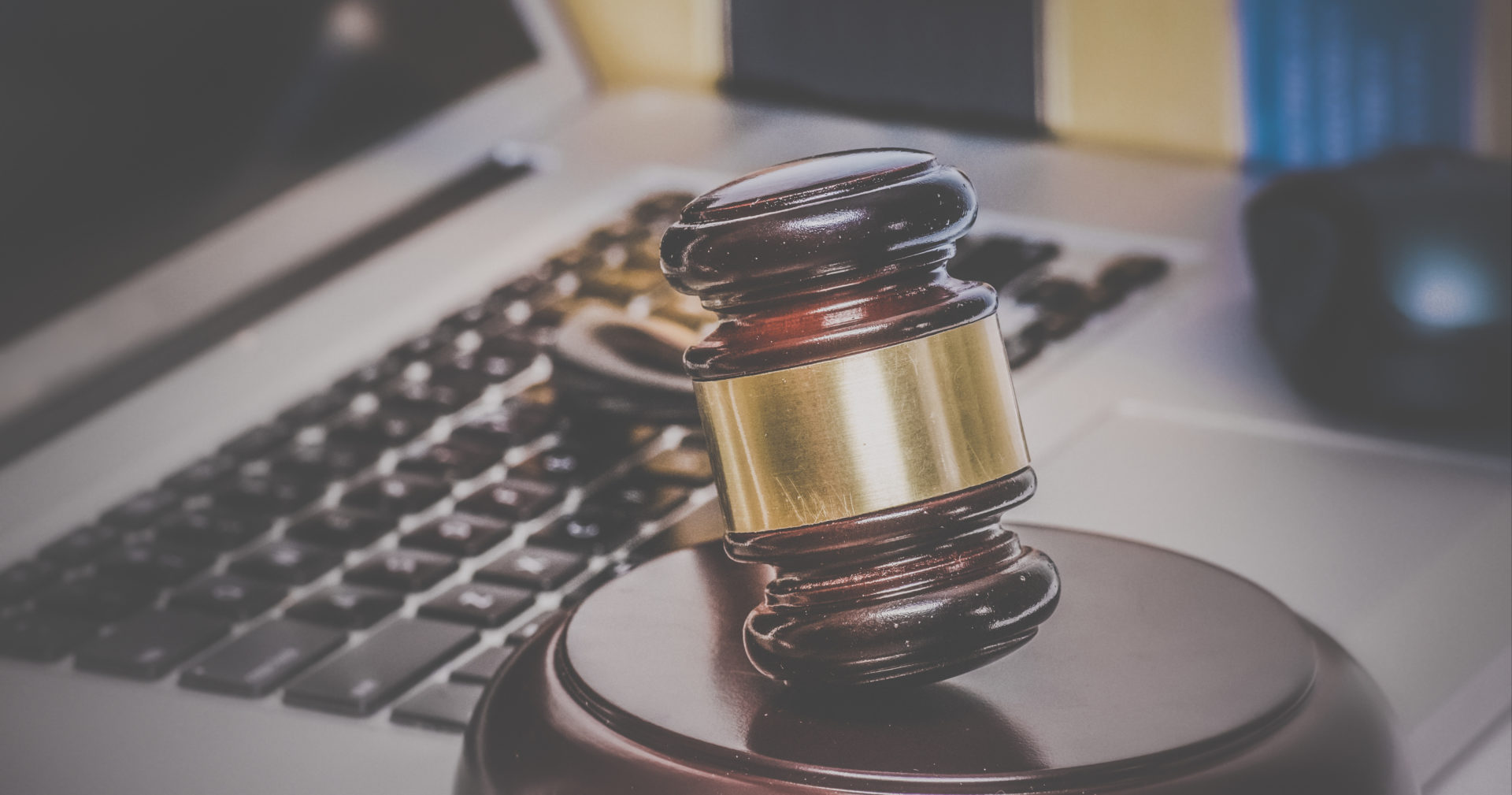 Gavel laying on top of a laptop