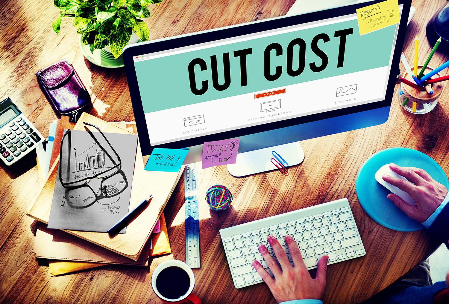 Computer with the words "Cut Cost" on the screen