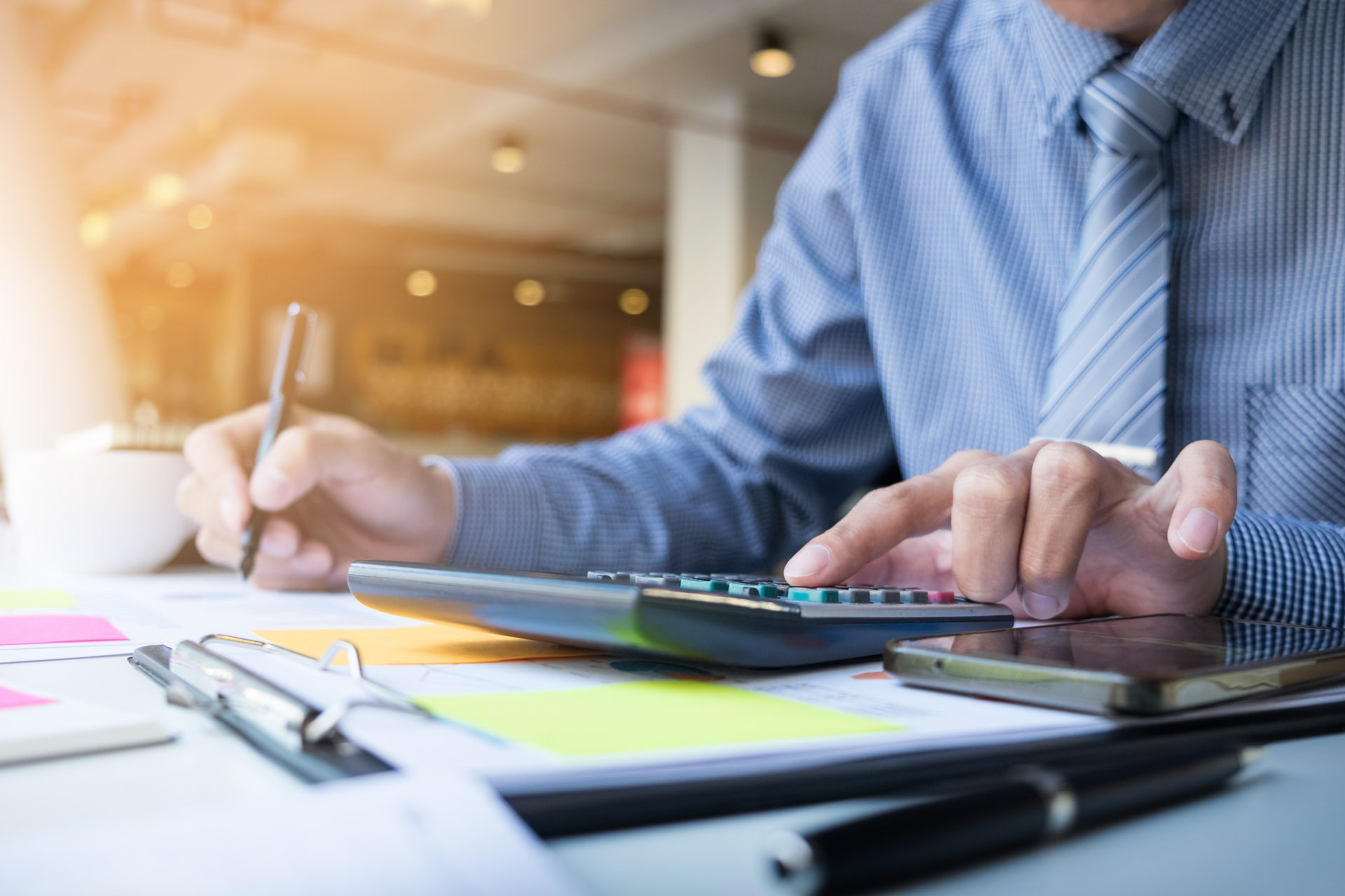 Male professional using a calculator
