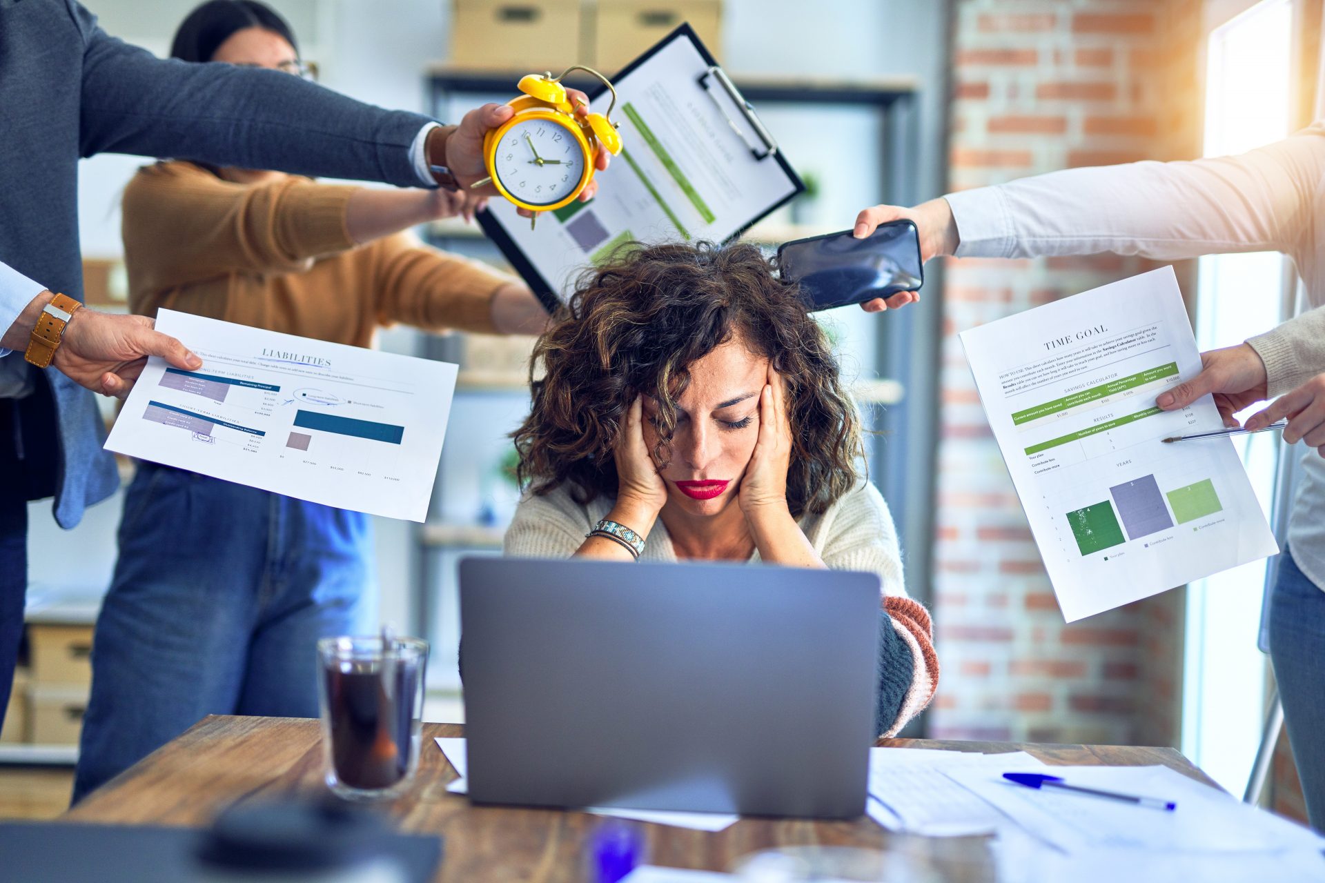 Female professional stressed out by her coworkers