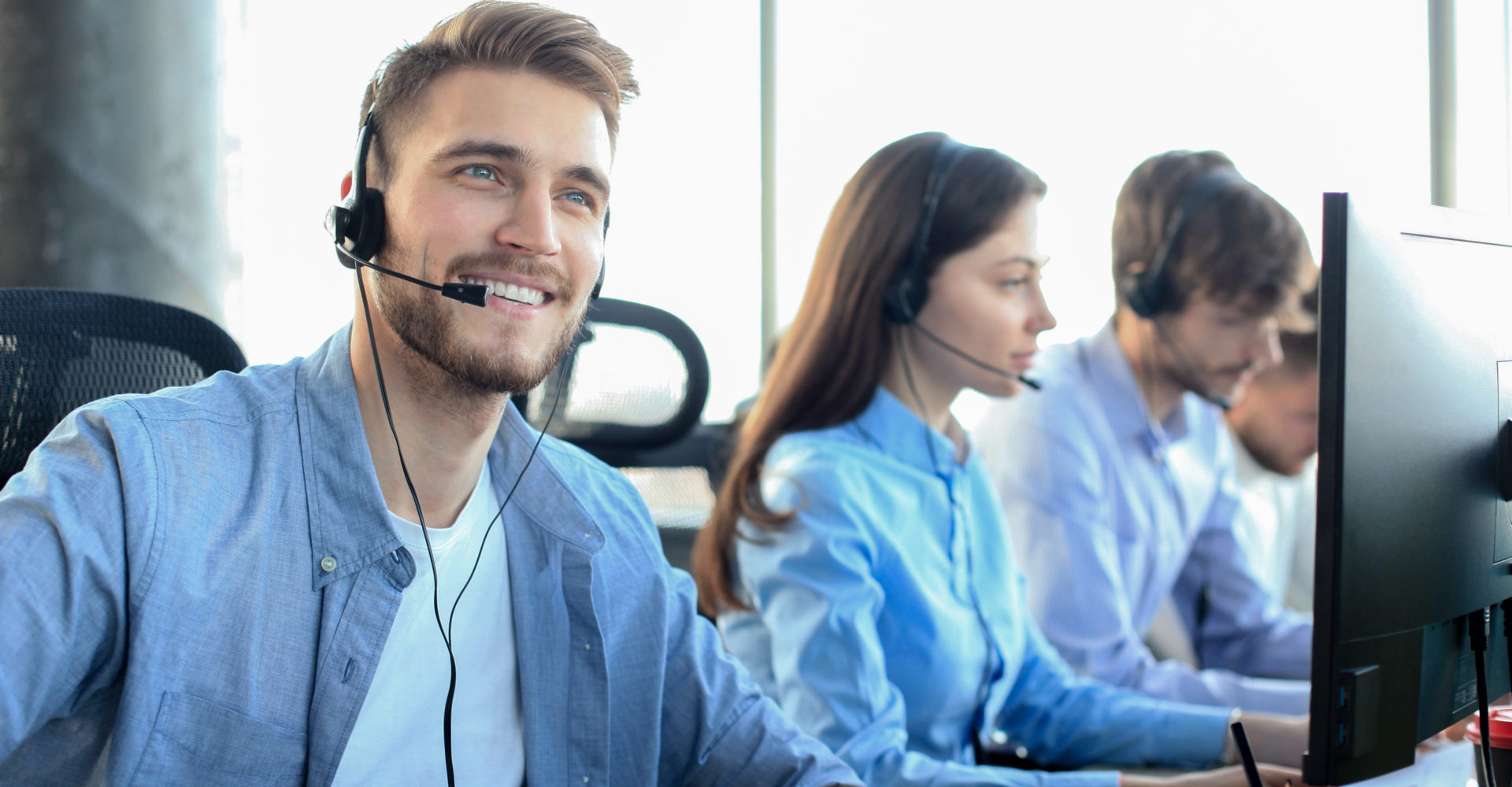 Male call center employee talking on his headset