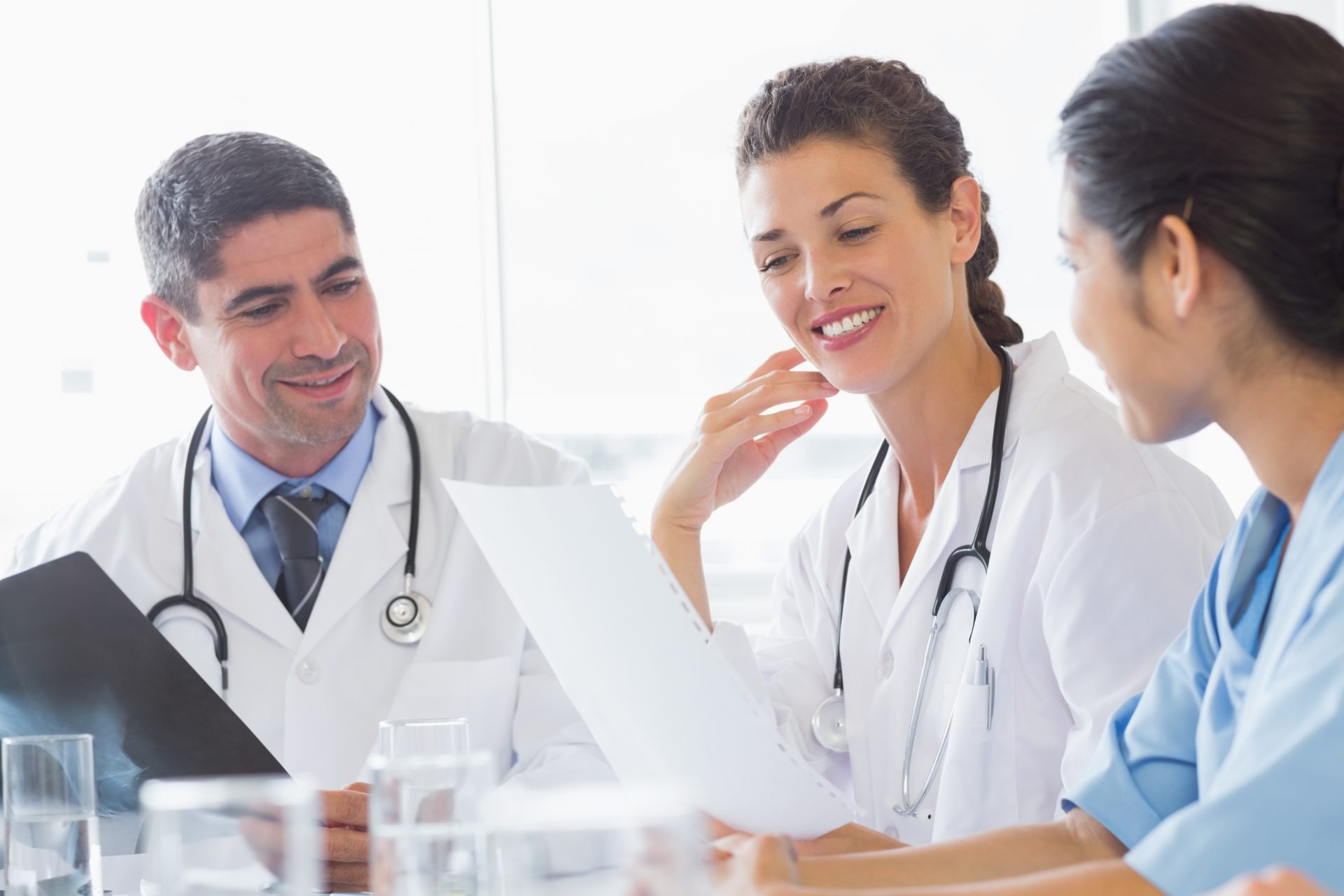 Three doctors looking over paperwork