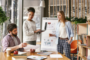 Three professionals in a creative meeting working on marketing strategies