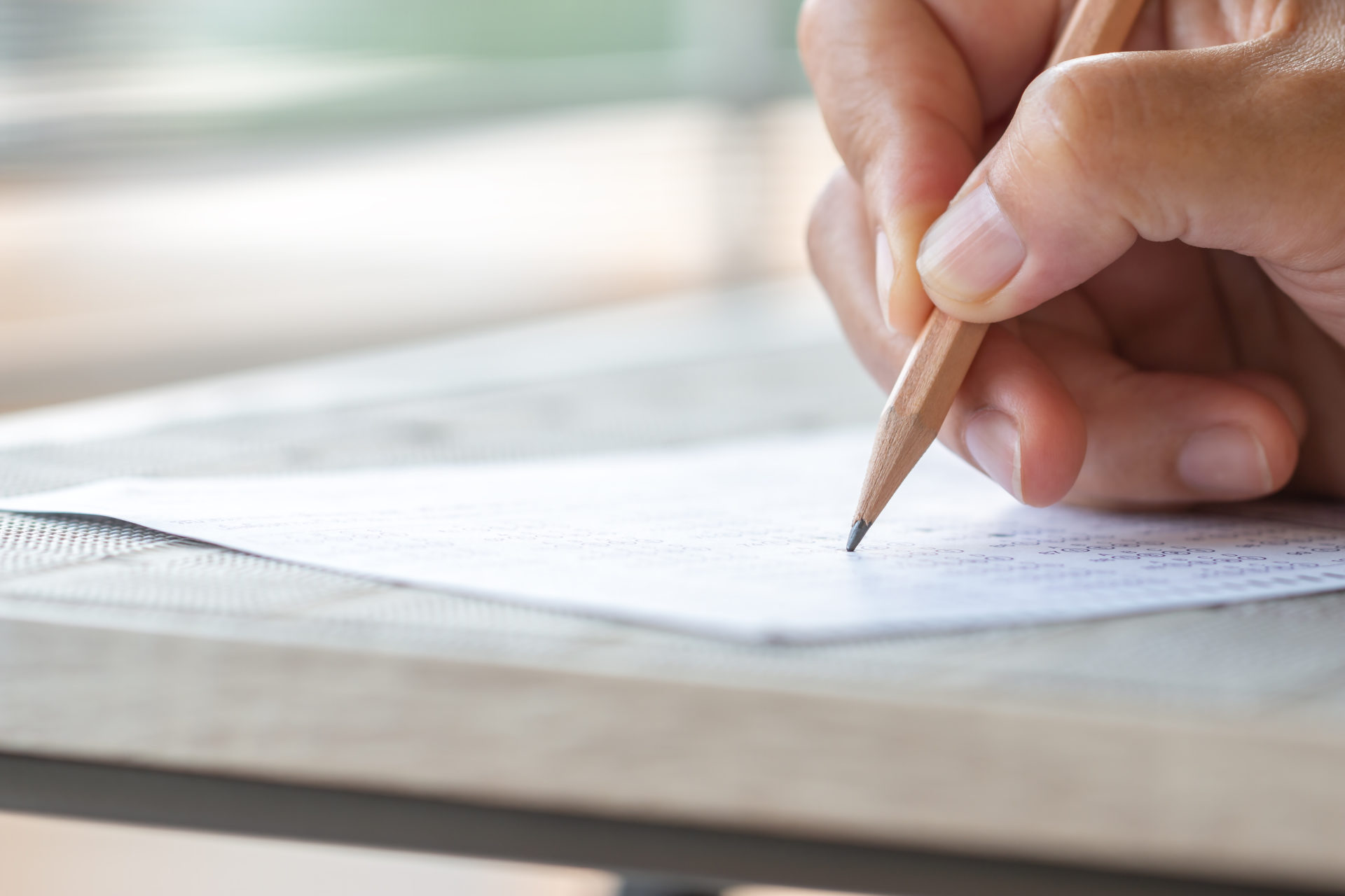 Professional using a pencil to take a pre-employment assessment