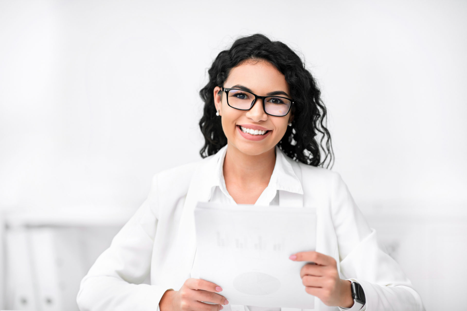 Female recruiter holding documents, looking at camera