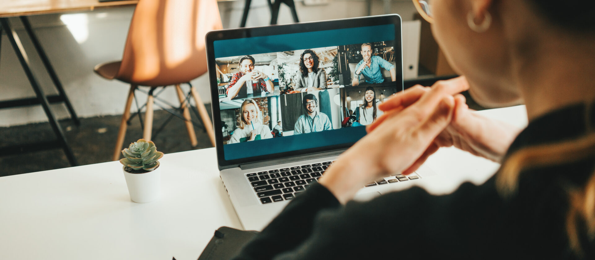Woman has video conference with her remote team she built using laptop and camera