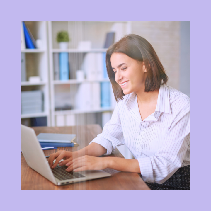 Smiling recruiter woman in a professional setting working on a laptop, searching for job candidates on a job board. Office environment with bookshelves in the background.