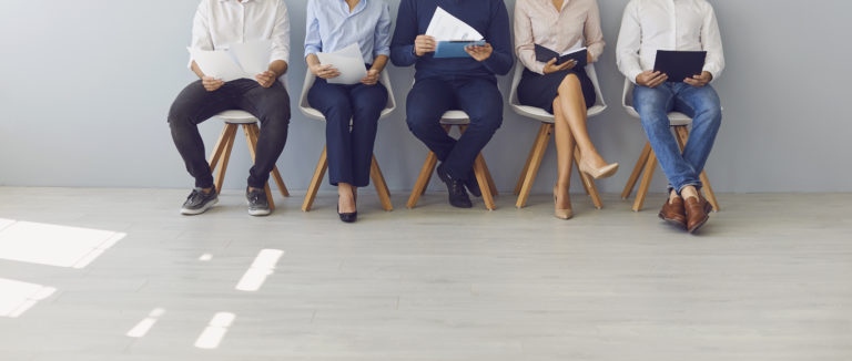 Group of people waiting in line for job interview