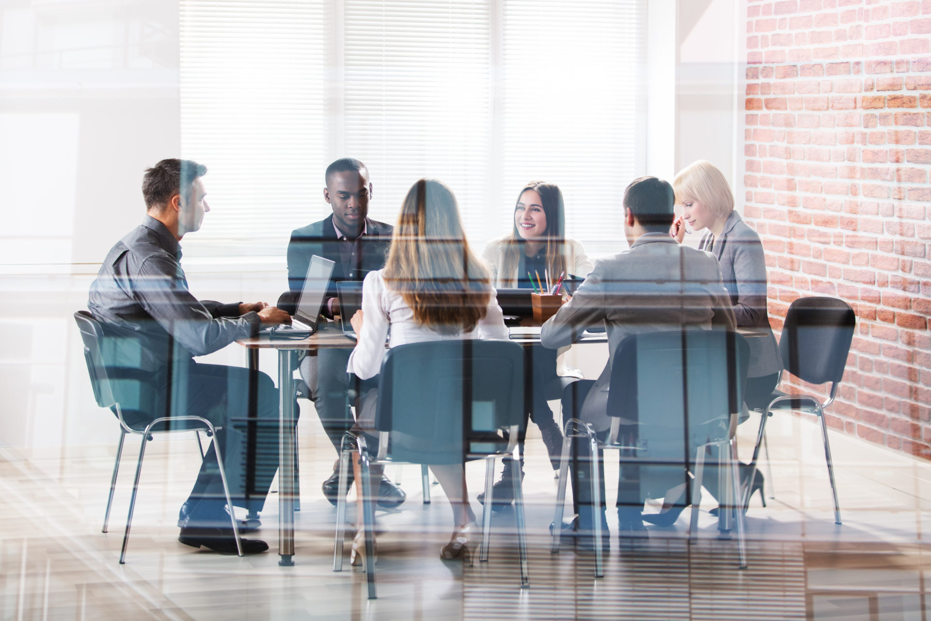 Diverse group of professionals sitting around a desk during an interview