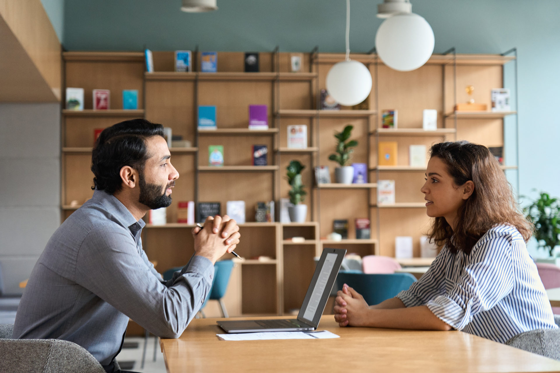 Male Manager listening to a female employee share her wish for a job transfer