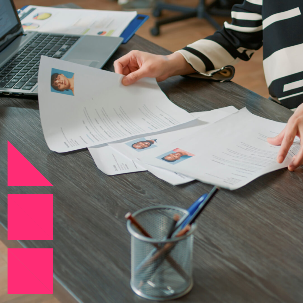 Female HR employee looking at resumes to recruit employees, analyzing information before job interview.