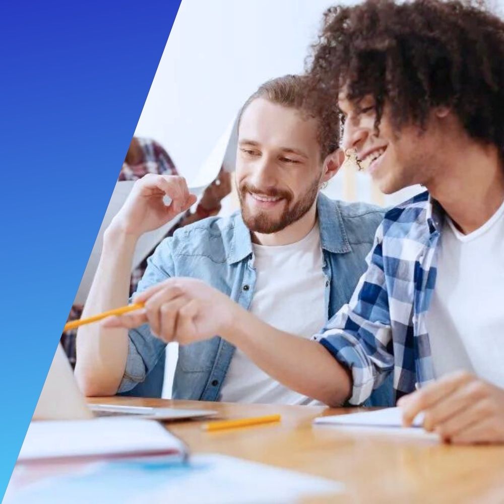Two young male professionals showing sign of excellent soft skills when discussing a project at work