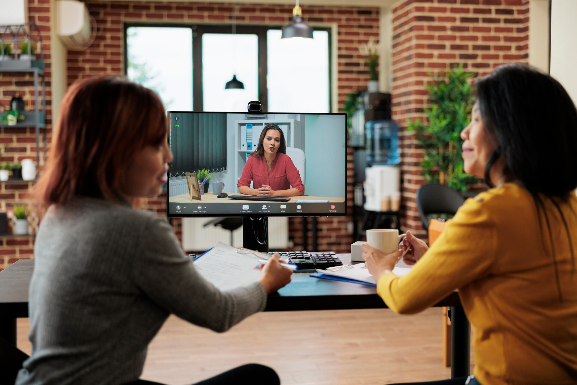 Job interview with remote applicant during online videocall meeting conference. Teleconference call on computer screen in startup office showing the future of recruiting