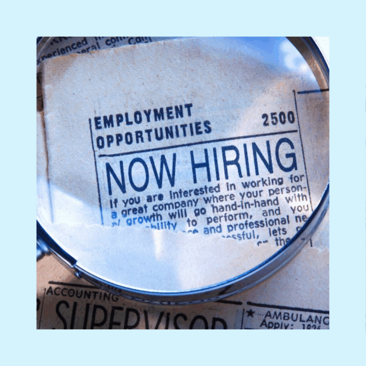 Magnifying glass over a newspaper section that shares a recruiting message