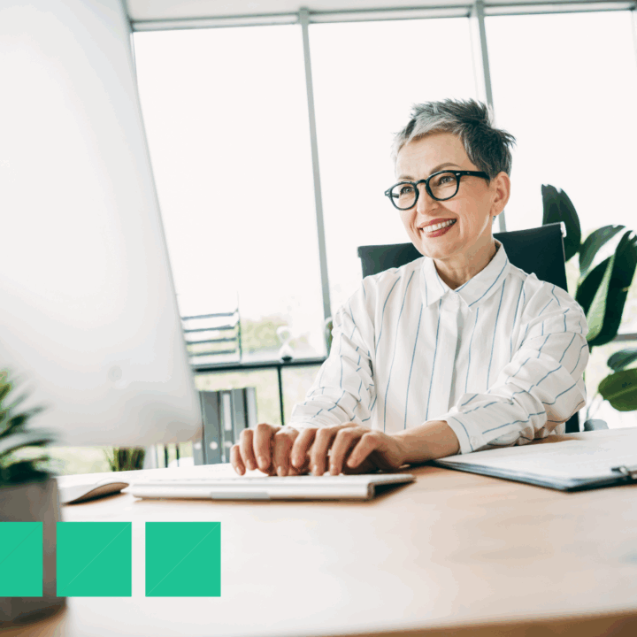ecruiter typing an email to a job candidate in a modern office, showcasing professional candidate communication and a positive hiring experience.