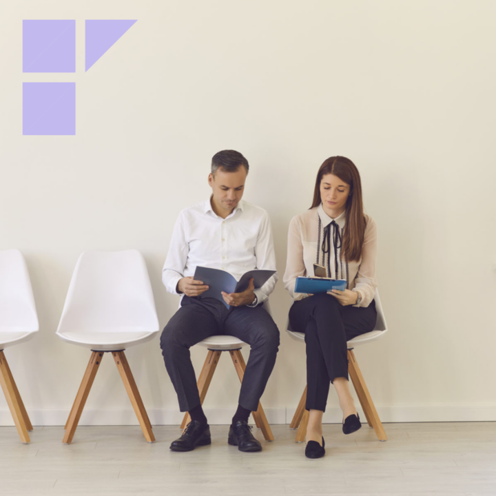 Two candidates with documents in their hands are sitting on chairs in the lobby waiting for an interview. Man and a woman compete for the same position.