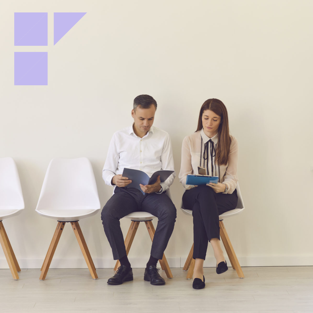 Two candidates with documents in their hands are sitting on chairs in the lobby waiting for an interview. Man and a woman compete for the same position.