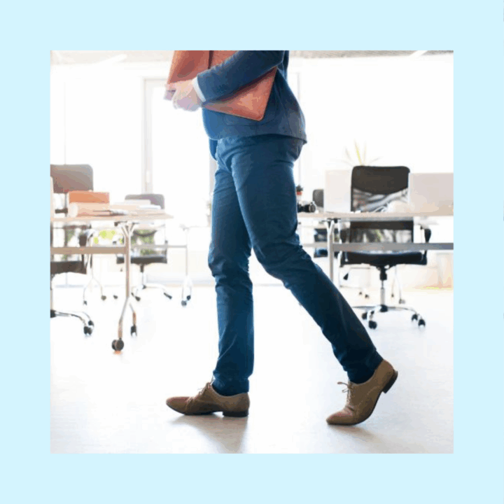 Male professional with briefcase walking by empty desks in an office signaling vacant positions that need to be filled