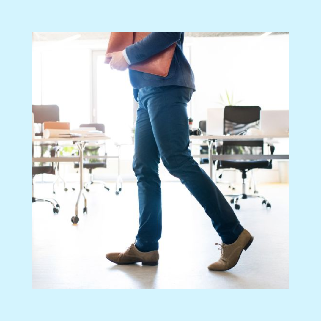 Male professional with briefcase walking by empty desks in an office signaling vacant positions that need to be filled