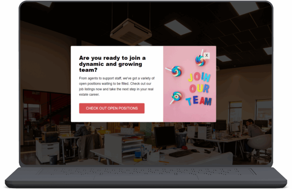 A laptop screen displays a hiring pop-up ad over an office background. The pop-up reads, “Are you ready to join a dynamic and growing team?” followed by text about open job positions and a red button labeled “CHECK OUT OPEN POSITIONS.” On the right side of the pop-up, there’s a pink panel with colorful lollipops and letters spelling out “JOIN OUR TEAM.”