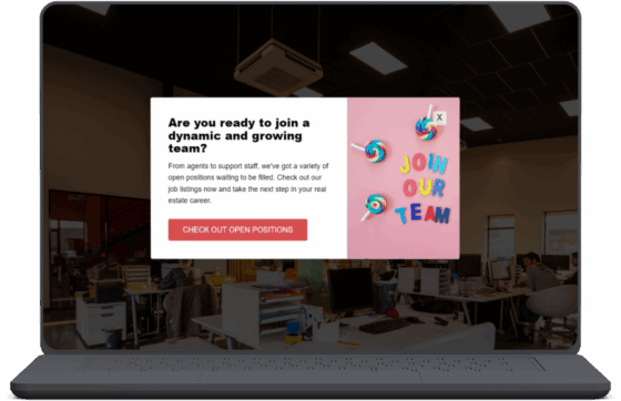 A laptop screen displays a hiring pop-up ad over an office background. The pop-up reads, “Are you ready to join a dynamic and growing team?” followed by text about open job positions and a red button labeled “CHECK OUT OPEN POSITIONS.” On the right side of the pop-up, there’s a pink panel with colorful lollipops and letters spelling out “JOIN OUR TEAM.”