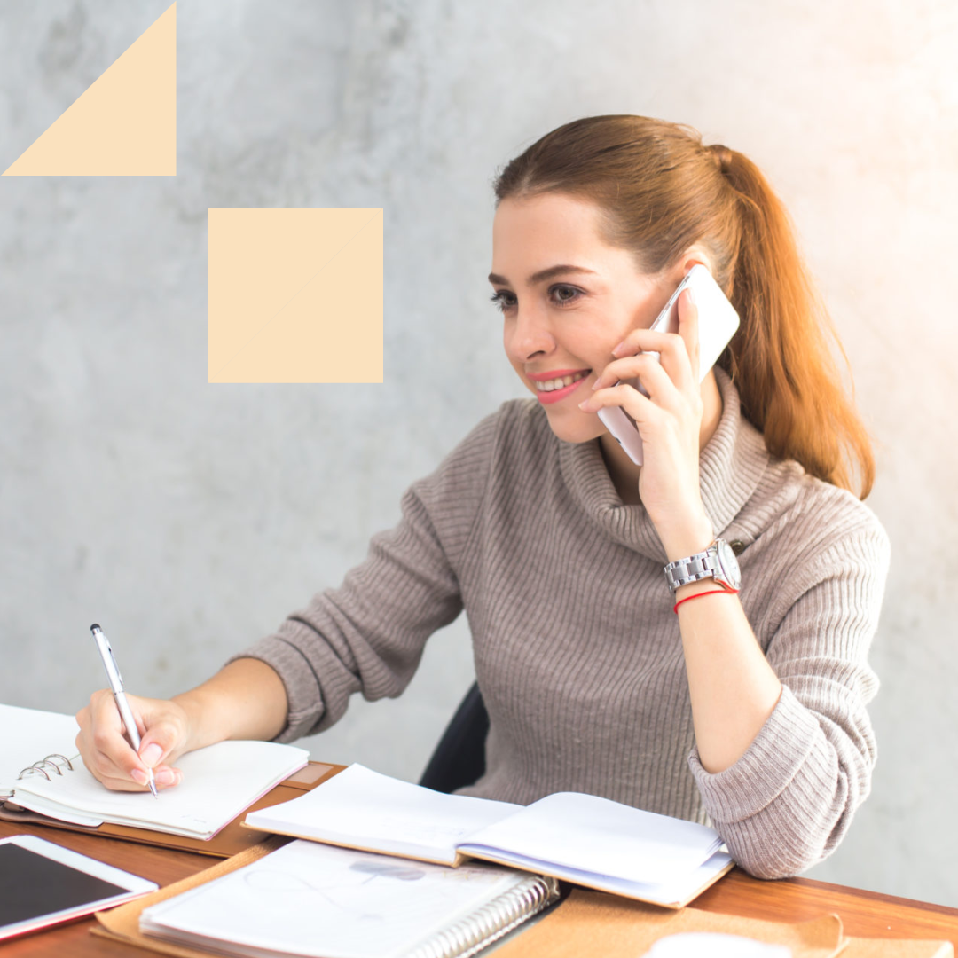 Female professional taking notes about how to conduct a phone interview