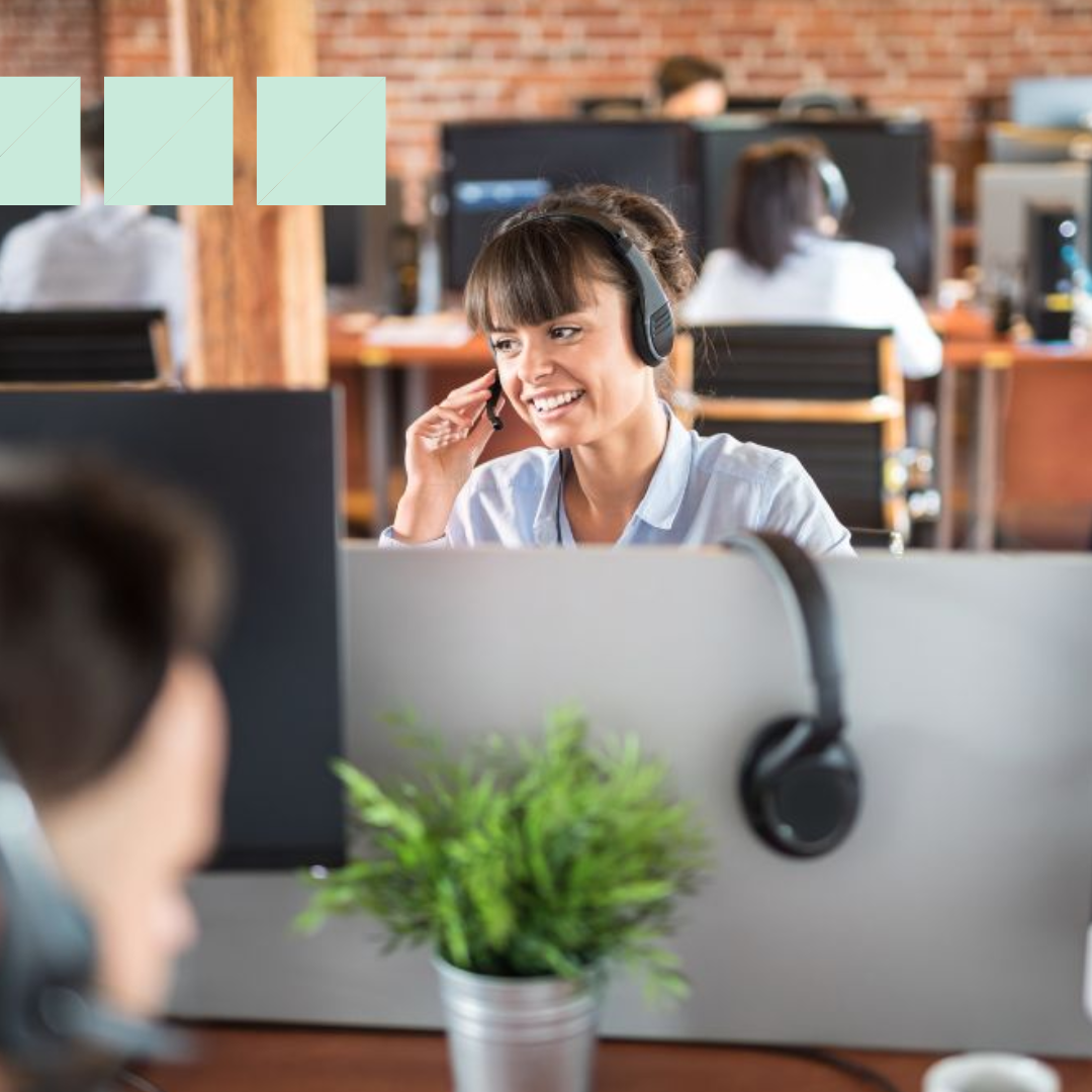 Third-party call center recruiter sitting an office at a desk talking into her headset