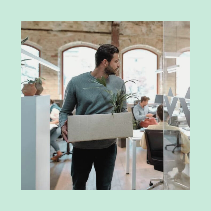 Man in casual wear holding box with personal things and leaving modern office. Job hopping and quitting concept.