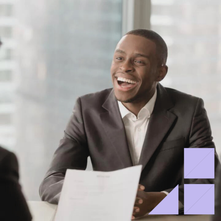 Male professional smiling and engaged during an interview