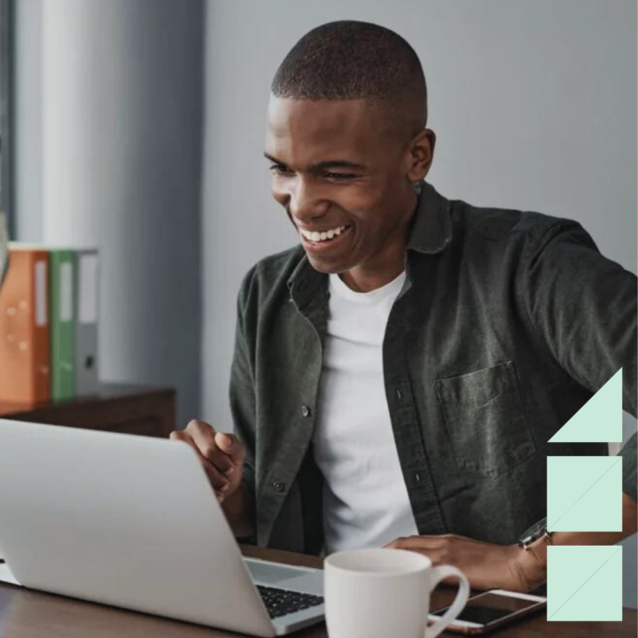 Shot of a young businessman using his laptop while working from home trying to increase his productivity.