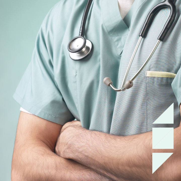 Male nurse in scrubs with a stethoscope, arms crossed.