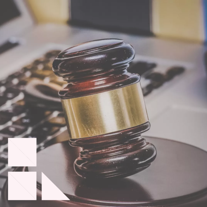 Gavel laying on top of a laptop