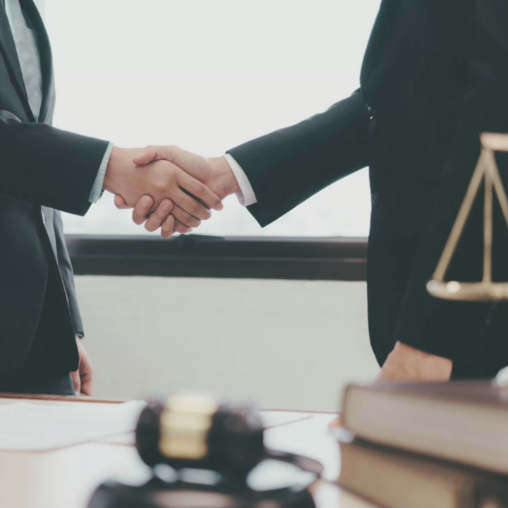 Two legal professionals shaking hands