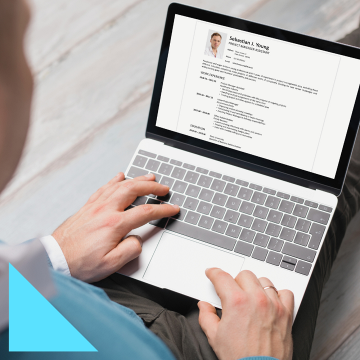 Close-up of a person typing on a laptop, reviewing a resume on the screen to ensure keywords with beat ATS