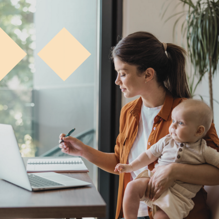Mom working from home on laptop while taking care of baby