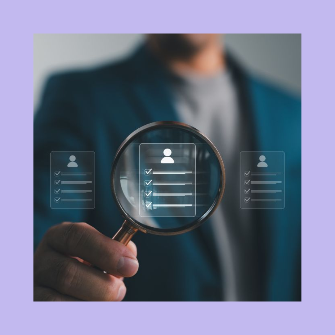 Male recruiter in a blue suit holding a magnifying glass up to an icon of a candidate's application with a light purple border. Shortlist candidates concept.