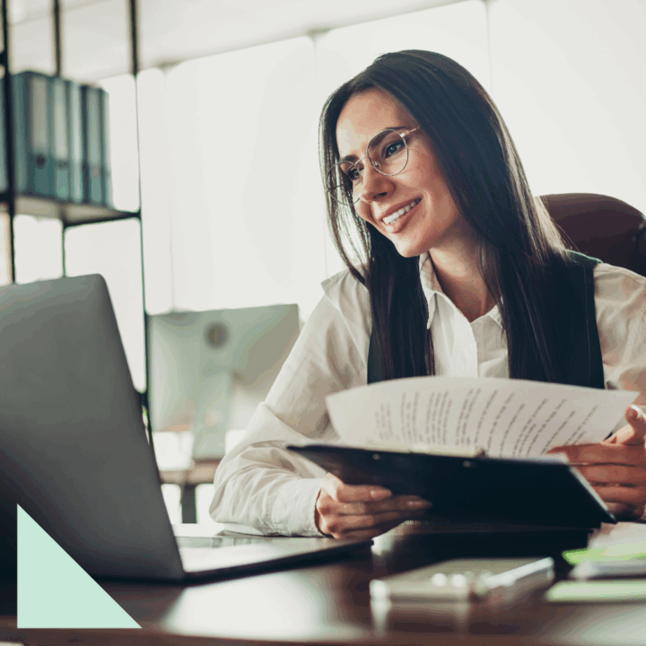 Human resources professional engaging with a job applicant over video call, holding resume documents and building a strong candidate experience.