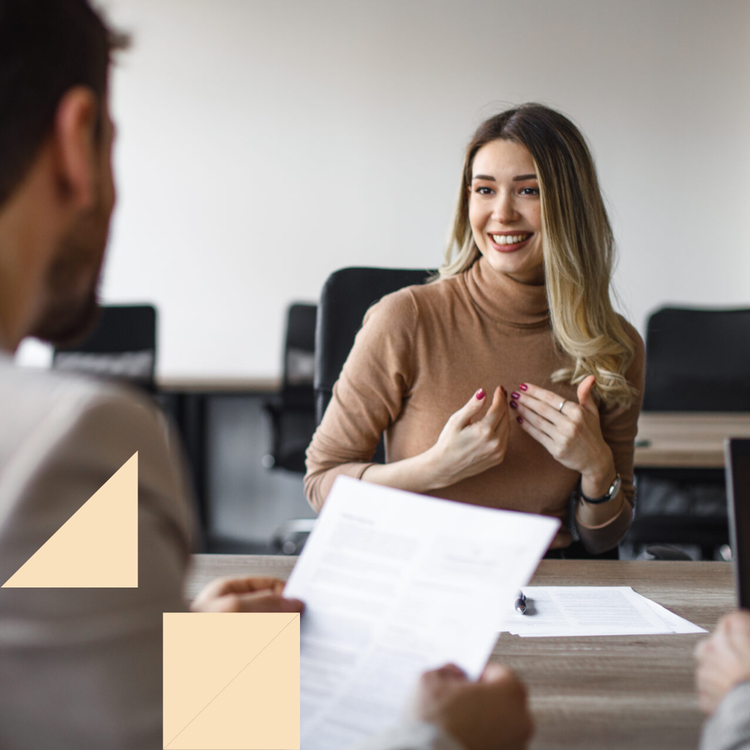 Male recruiter interviewing female HR candidate for an open position in a modern office