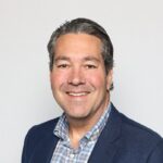 A closeup of Pete Newsome, looking into the camera and smiling.