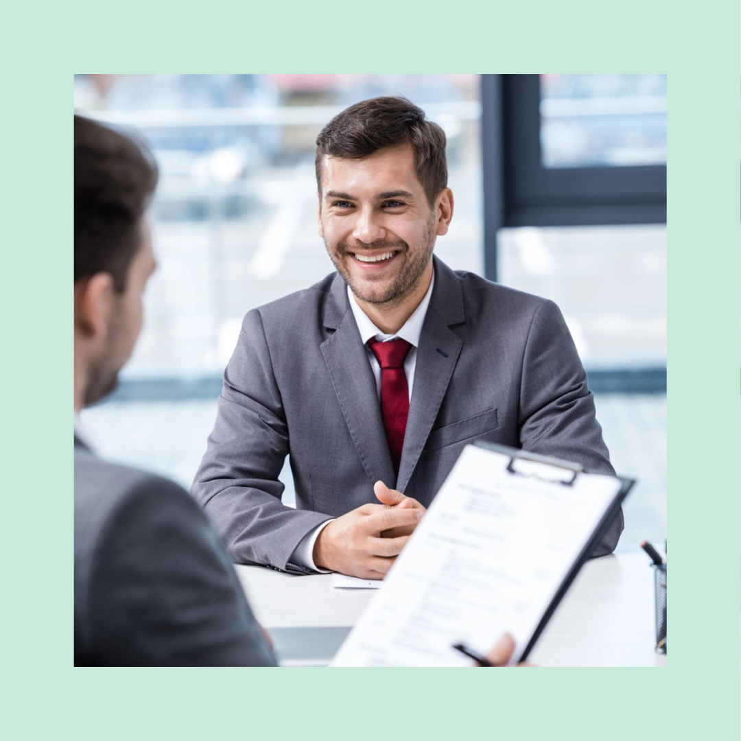 Finance interview between a hiring manager and professional candidate in a modern office, reviewing a resume and evaluating accounting, budgeting, and financial analysis experience.