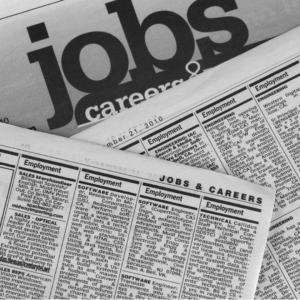 Stack of newspaper job listings and classifieds with the headline “Jobs & Careers,” representing job openings, hiring news, and employment opportunities.