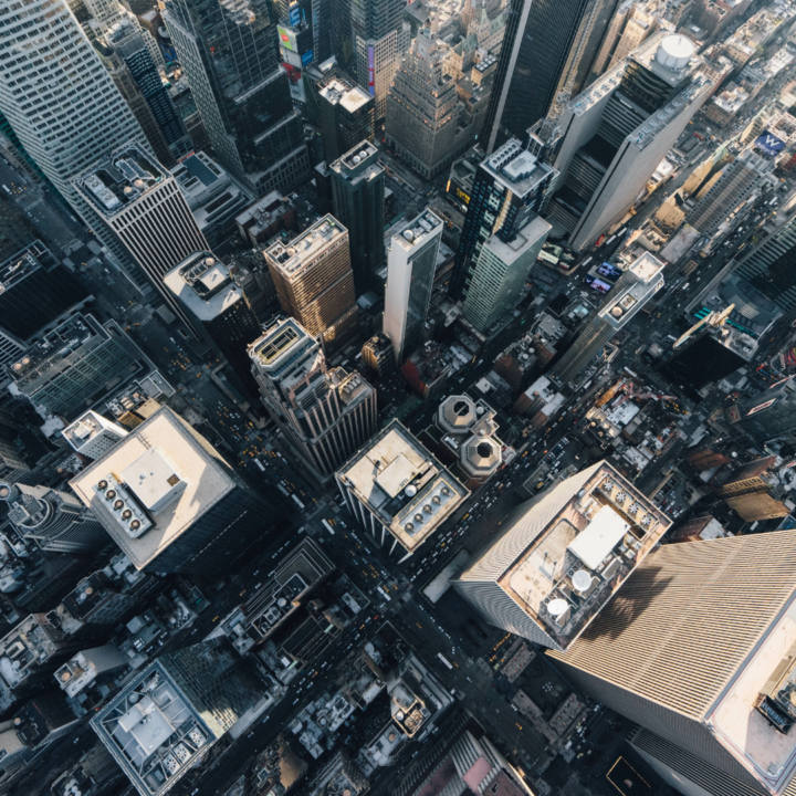 Aerial view of a dense urban city center with skyscrapers and busy streets, representing employment trends, economic activity, and the broader job market.