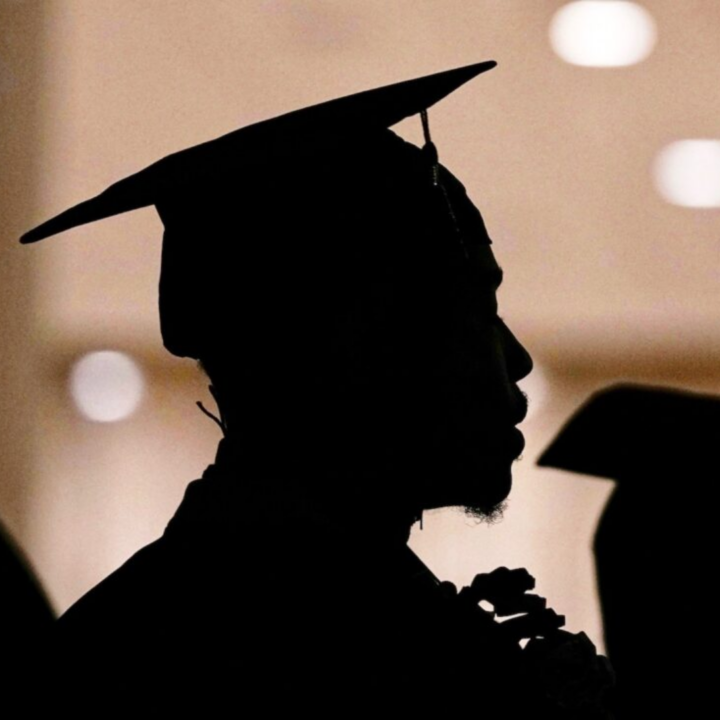Silhouette of a college graduate wearing a cap and gown