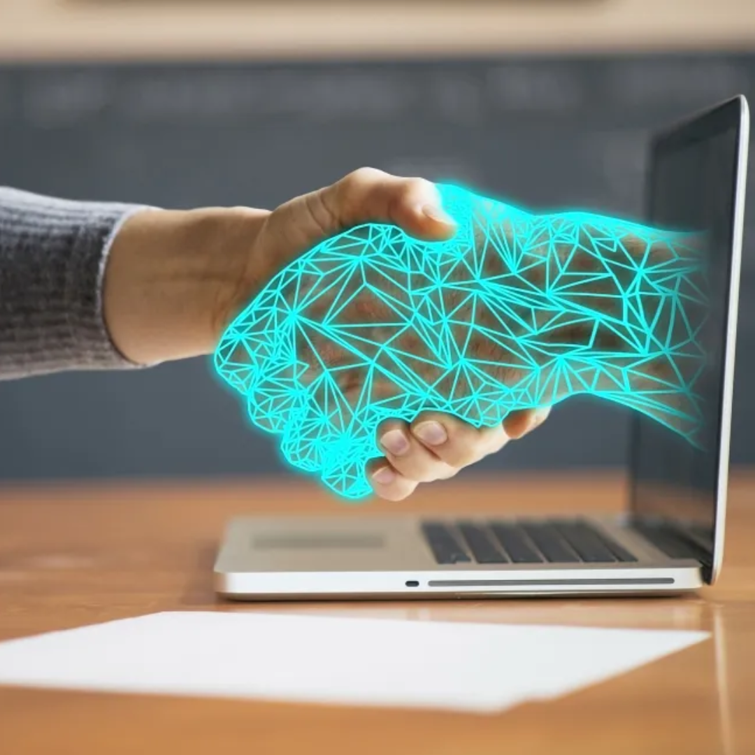 Person shaking a digital, AI-generated hand emerging from a laptop