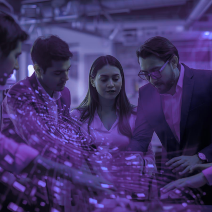 Team of professionals gathered around a glowing digital holographic interface in a purple-lit tech environment