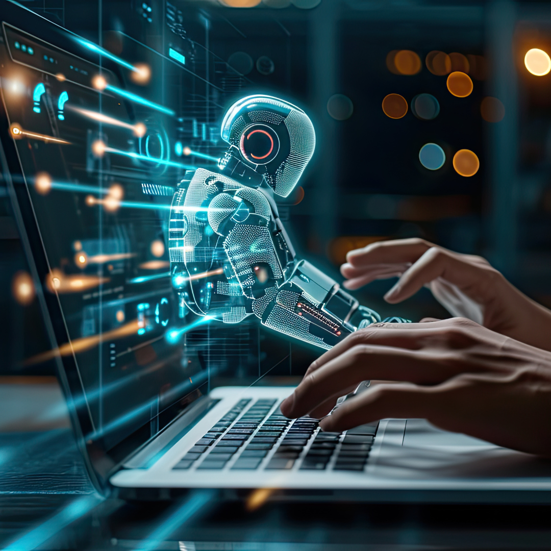 Glowing AI robot hologram emerging from a laptop screen alongside human hands typing, representing artificial intelligence and human collaboration